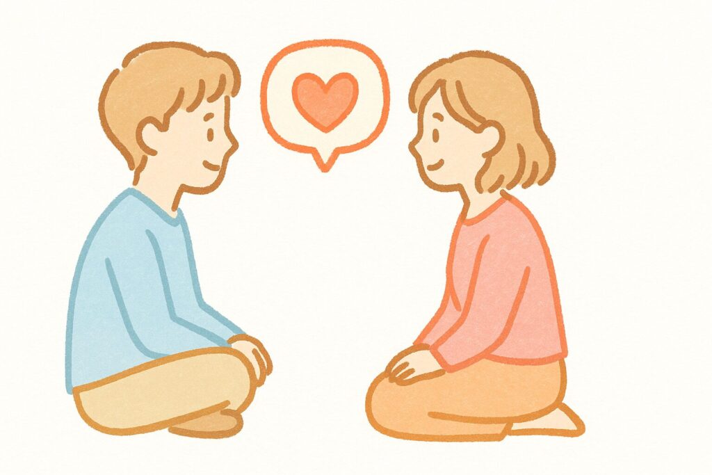 向かい合って座り、ハートの吹き出しで会話している男女のイラスト
